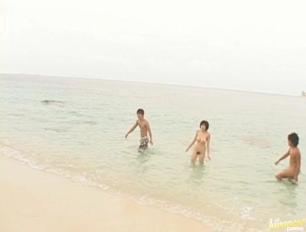 Hot and sexy brunette Asian babe gagging hard cocks and double penetrated on the beach