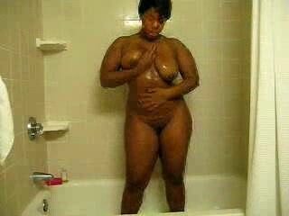 Ebony bitch with curves washes her brown twat in the shower