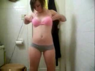 Small-titted babe dances and strips to the music