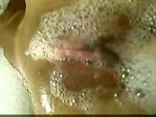 Sexy Latina soaps and caresses her shaved pussy