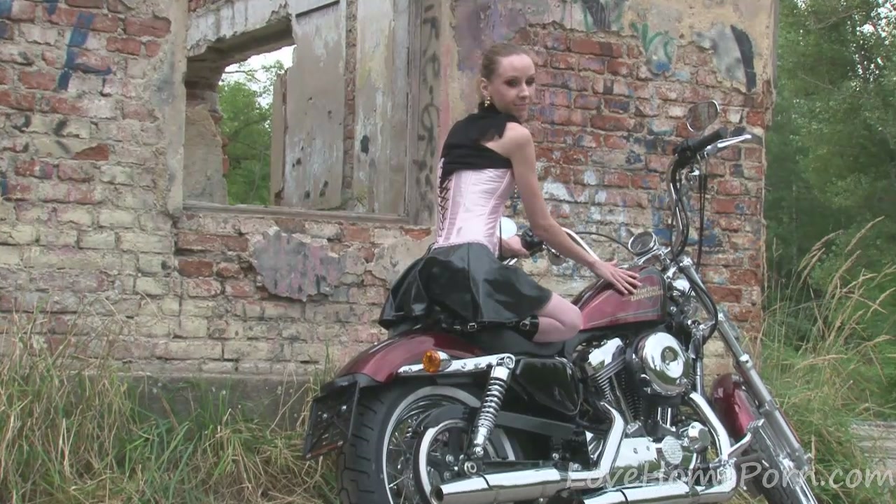 Cute teen 18+ is amazed by a big bike