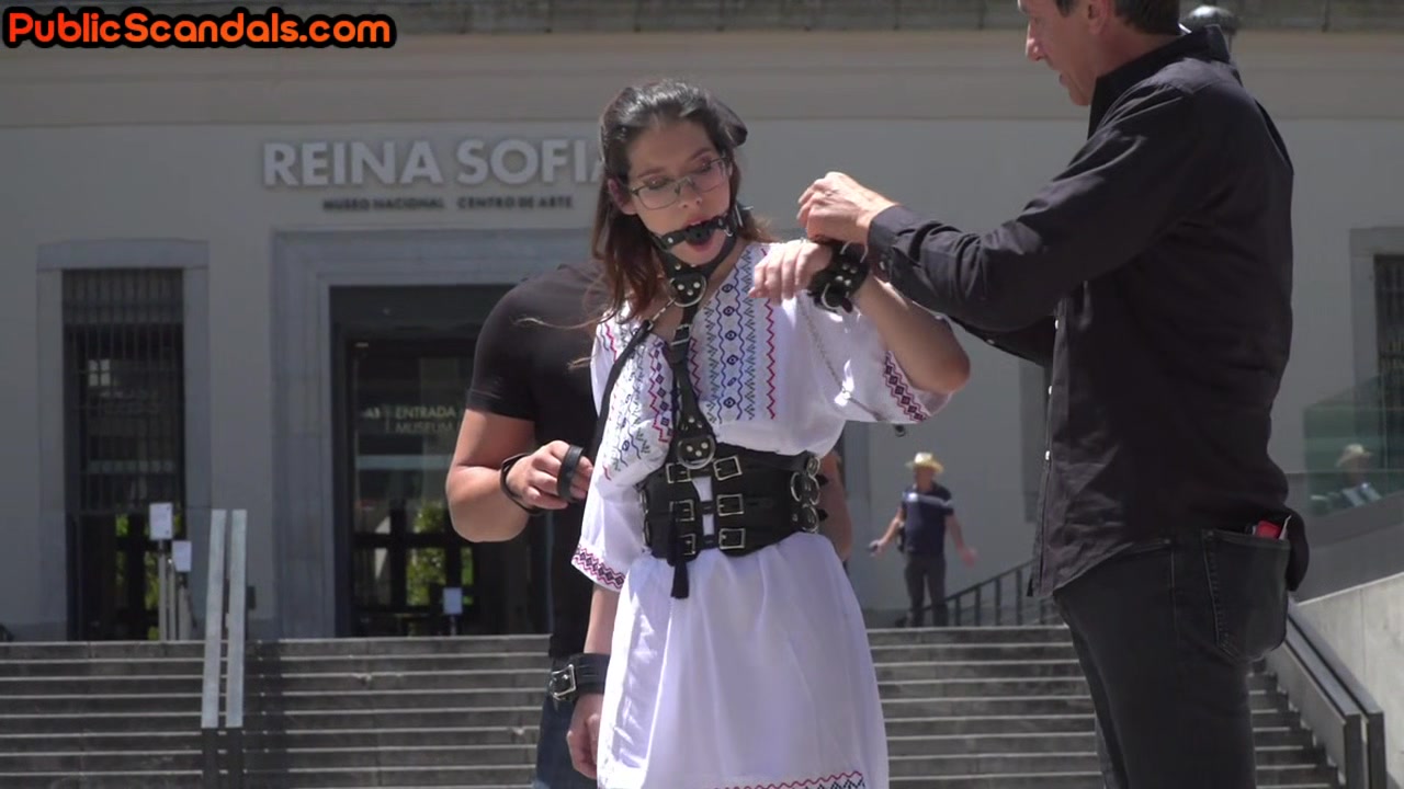 BDSM babe deepthroats in public while being body whipped