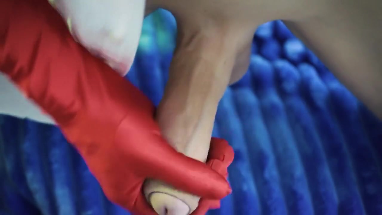 A Man Masturbates His Penis On A Chair Wearing Red And White Gloves