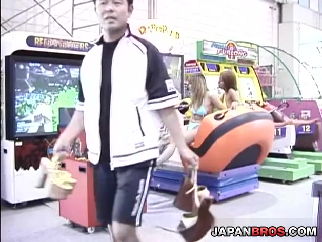 Beautiful Asian babes in bikini give a double blowjob in a public place!