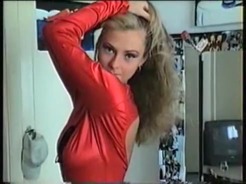 Hot young blonde in red sexy dress demonstrates her body