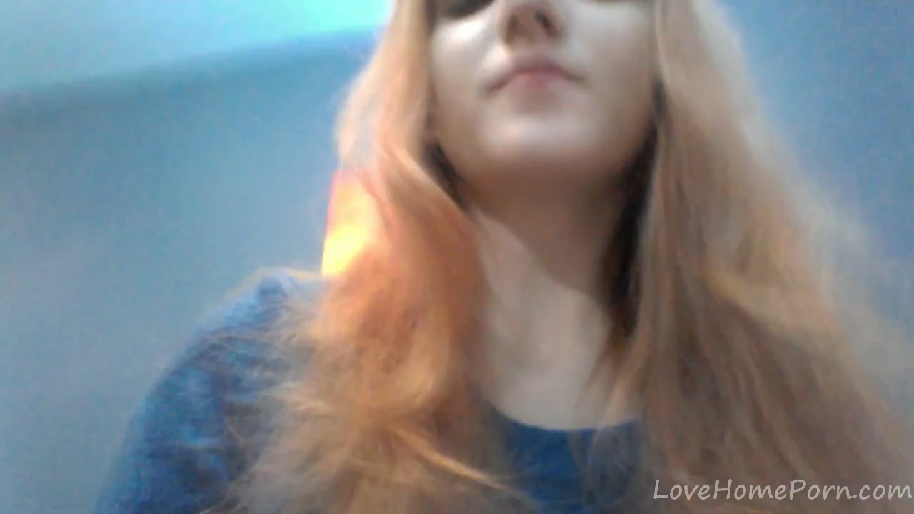 Redhead in a red dress rubs her pussy