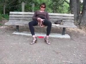 Lovely crossdresser jerks it on a park bench