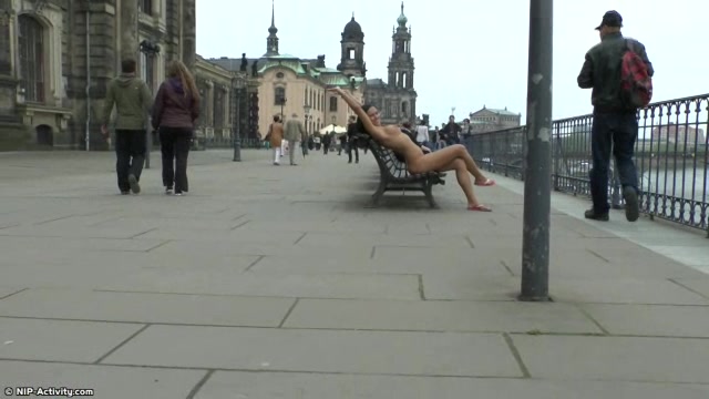 Long haired brunette walks naked in public in hd movie