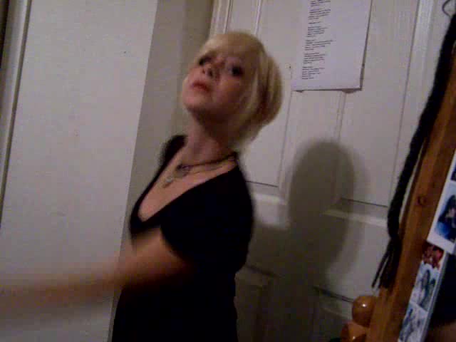 Short-haired blonde girl dances in the homemade video