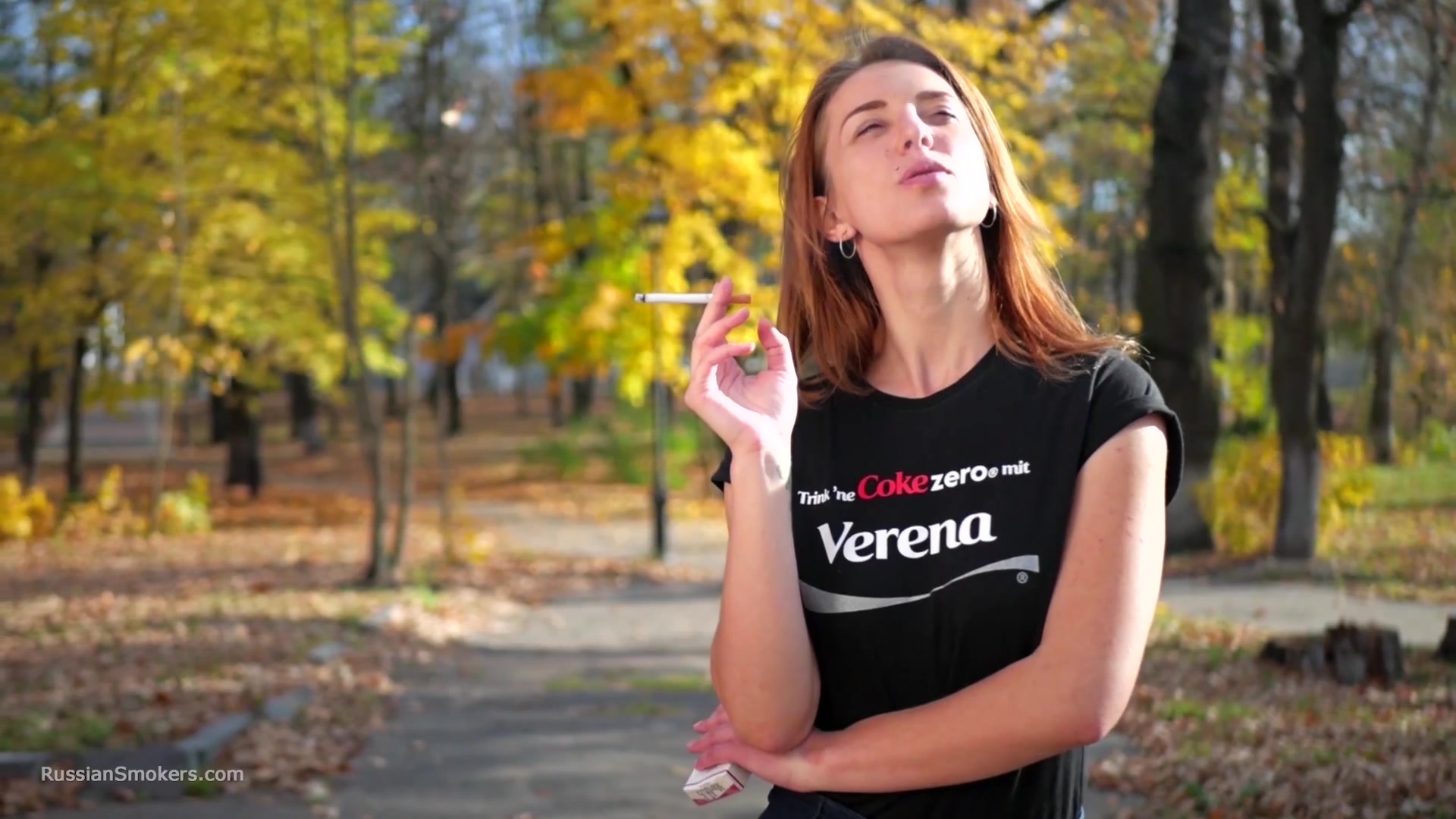 Sasha Is Smoking Two Cigarettes One By One In The Autumn Park
