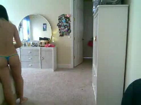Petite and sexy Japanese babe puts on clothes on the webcam