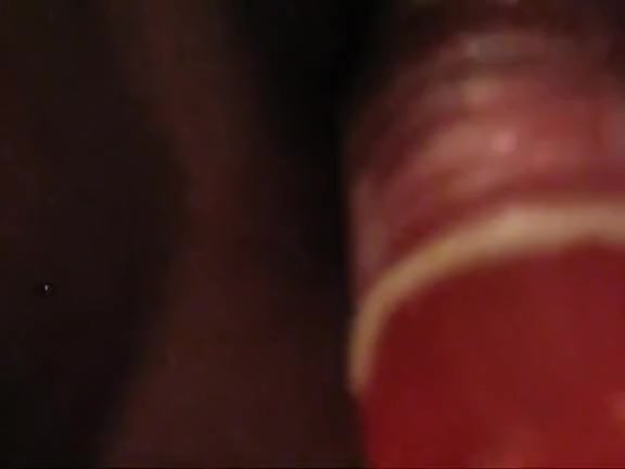 Sexy Ebony chick penetrating her hairy pussy with a red toy