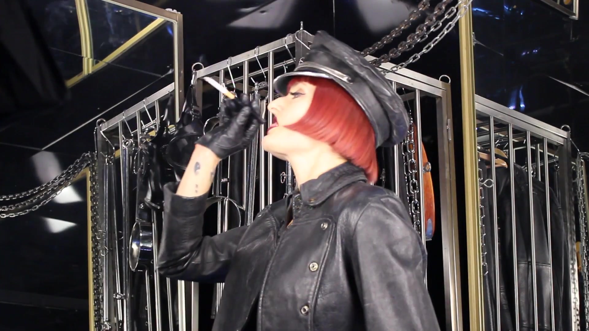 Mistress Tokyo Smoking Cigarette In Leather, Gloves And Muir Cap
