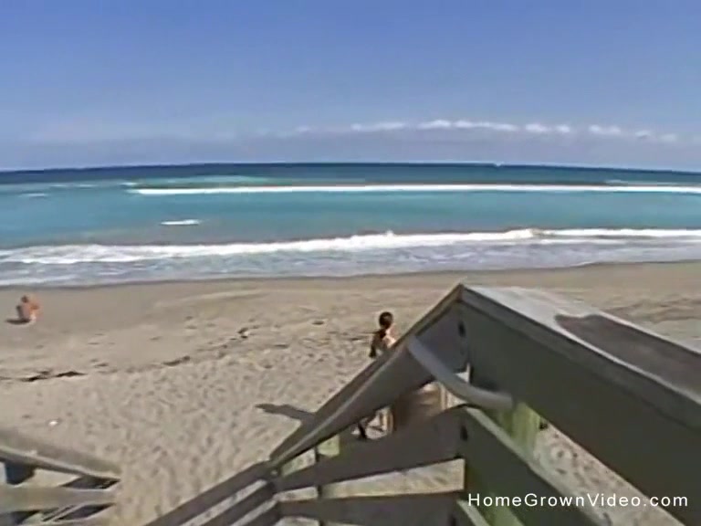 Handjob from busty brunette on beach