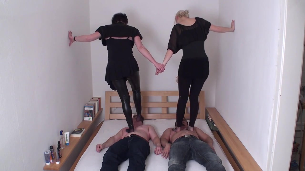 Brunette and blonde are trampling on their slaves by Femdom Austria