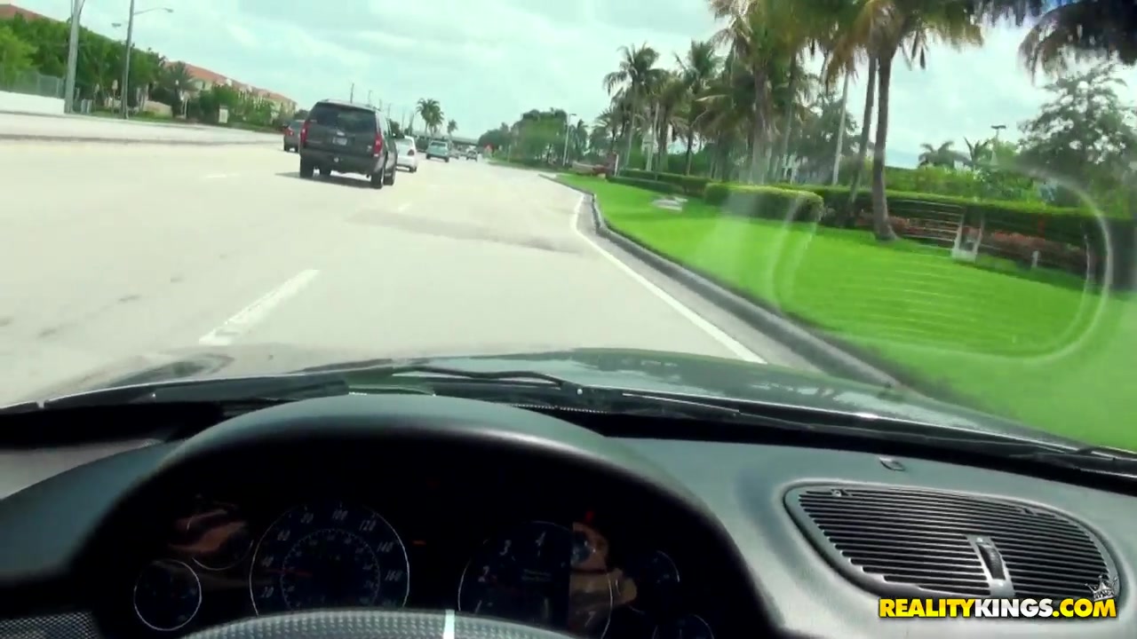 Caprice sucks on a dong while driving