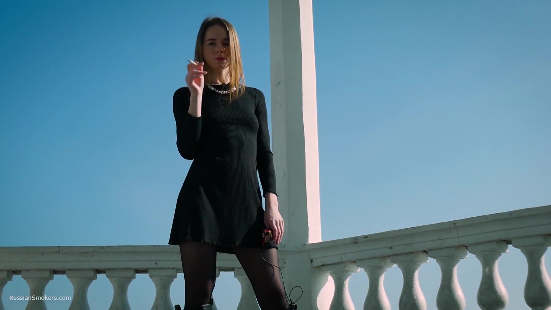 Slim Chick Basks In The Sun With A Cigarette In Her Hand