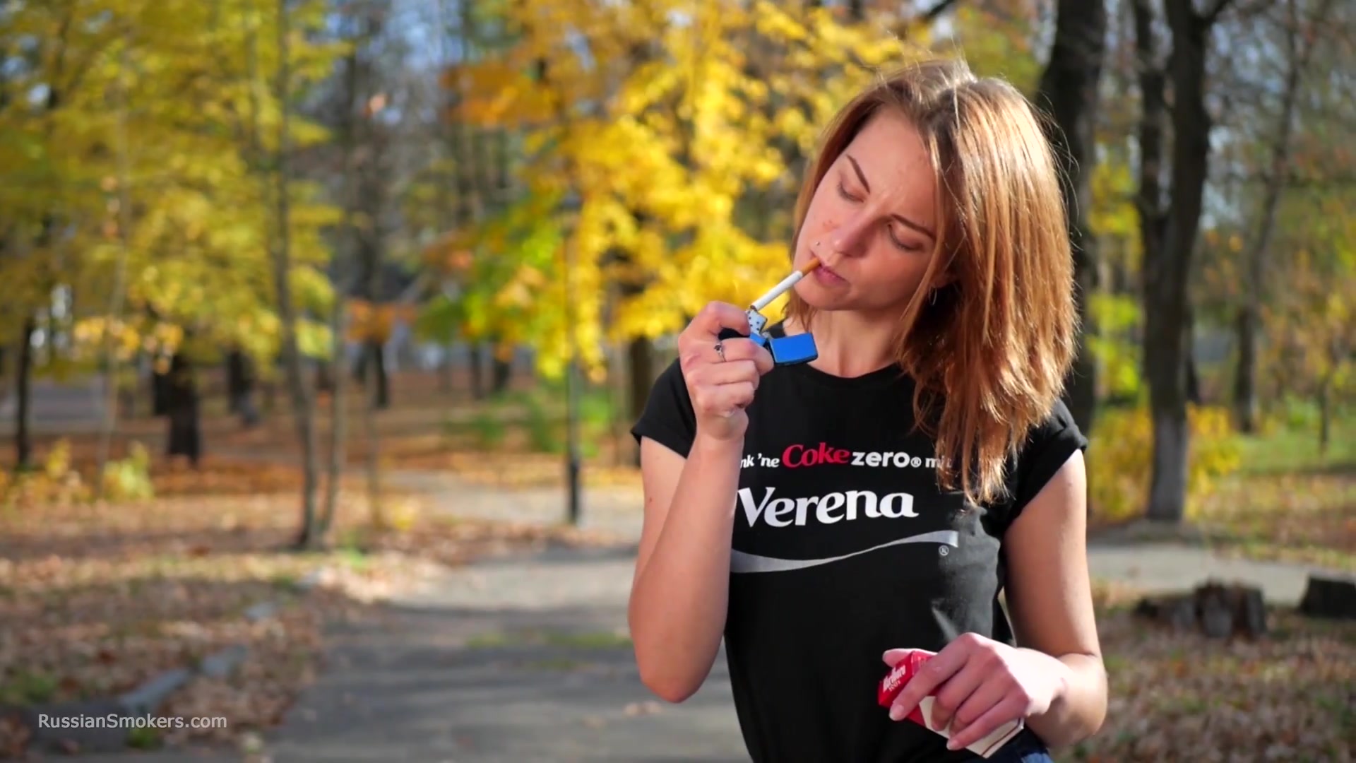 Sasha Is Smoking Two Cigarettes One By One In The Autumn Park
