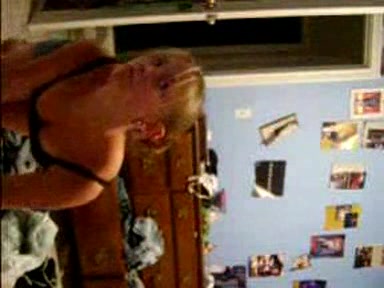 Blonde young girl taking her clothes off slowly