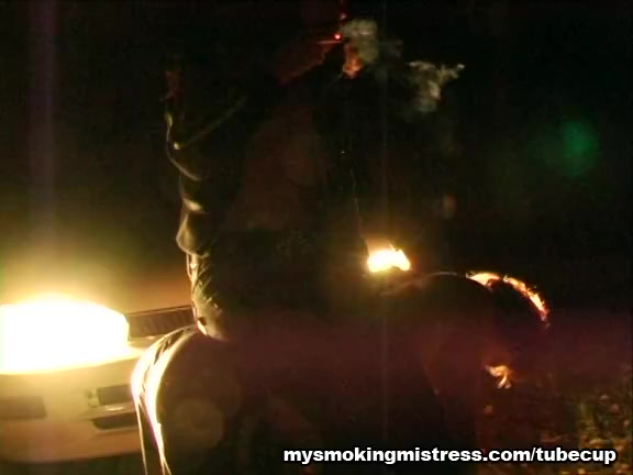 Smoking Mistress Sits on Slave