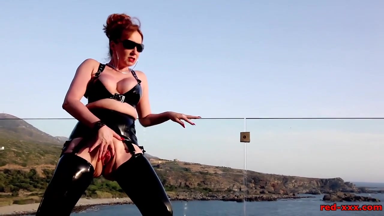 Mature British redhead masturbates on the balcony