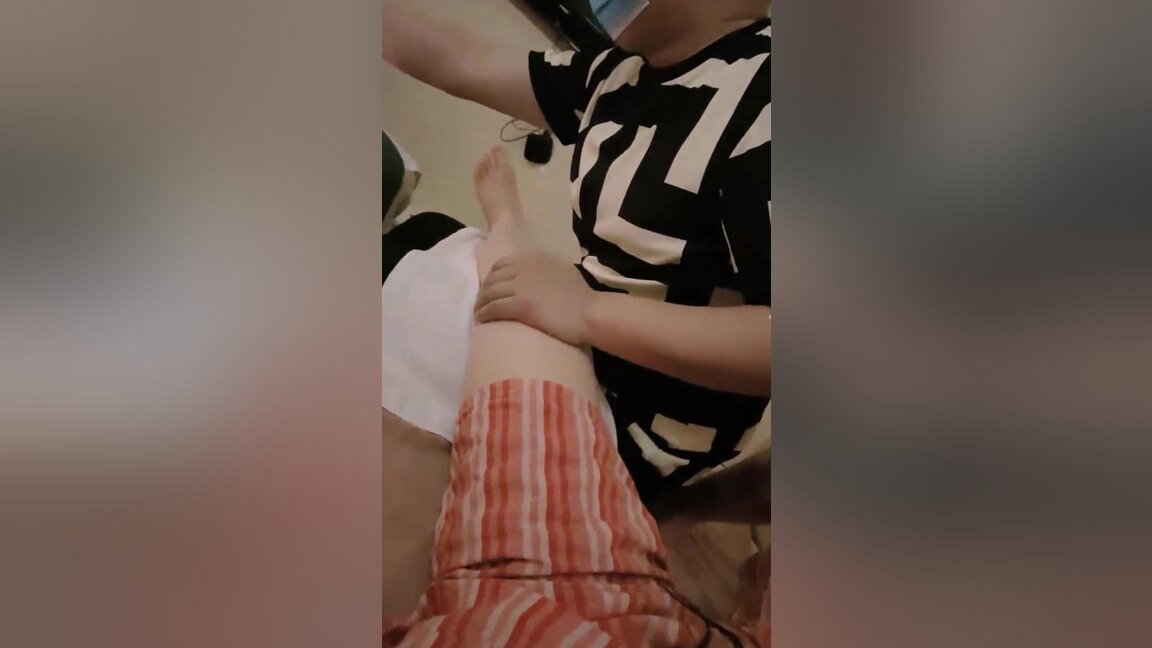 An Asian woman is seen urinating on in a public washroom