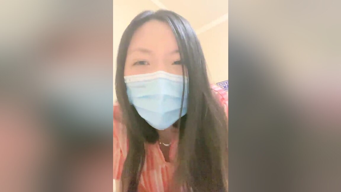 An Asian woman is seen urinating on in a public washroom