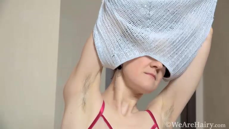 Alise strips naked on her leather couch