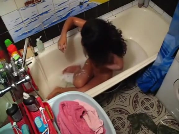 Tanned solo chick in the bathtub