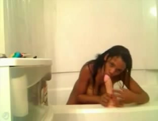 Latina wench masturbating with a large dildo in bathroom
