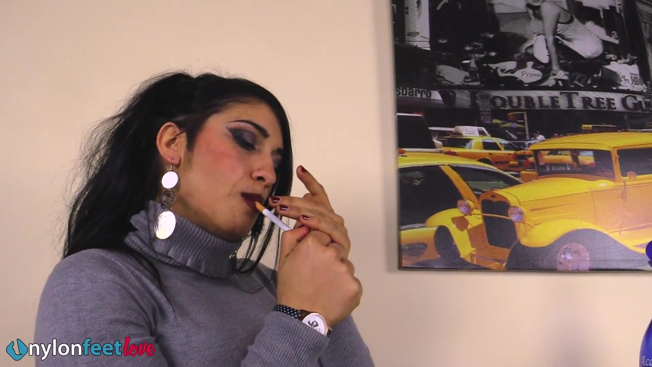 Gorgeous Sharon smoking a cigarette and showing off her nyloned feet