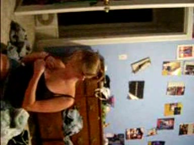Blonde young girl taking her clothes off slowly