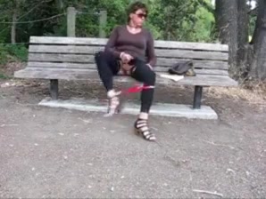 Lovely crossdresser jerks it on a park bench