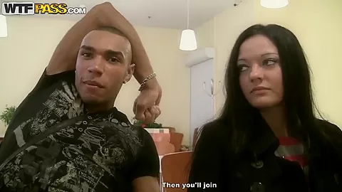 Brunette Aurora gives blowjob to two dicks in public toilet