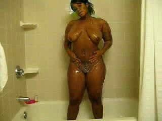 Ebony bitch with curves washes her brown twat in the shower