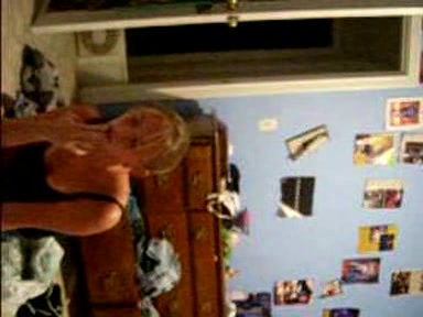 Blonde young girl taking her clothes off slowly