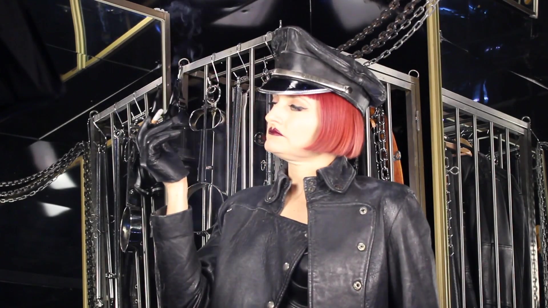 Mistress Tokyo Smoking Cigarette In Leather, Gloves And Muir Cap