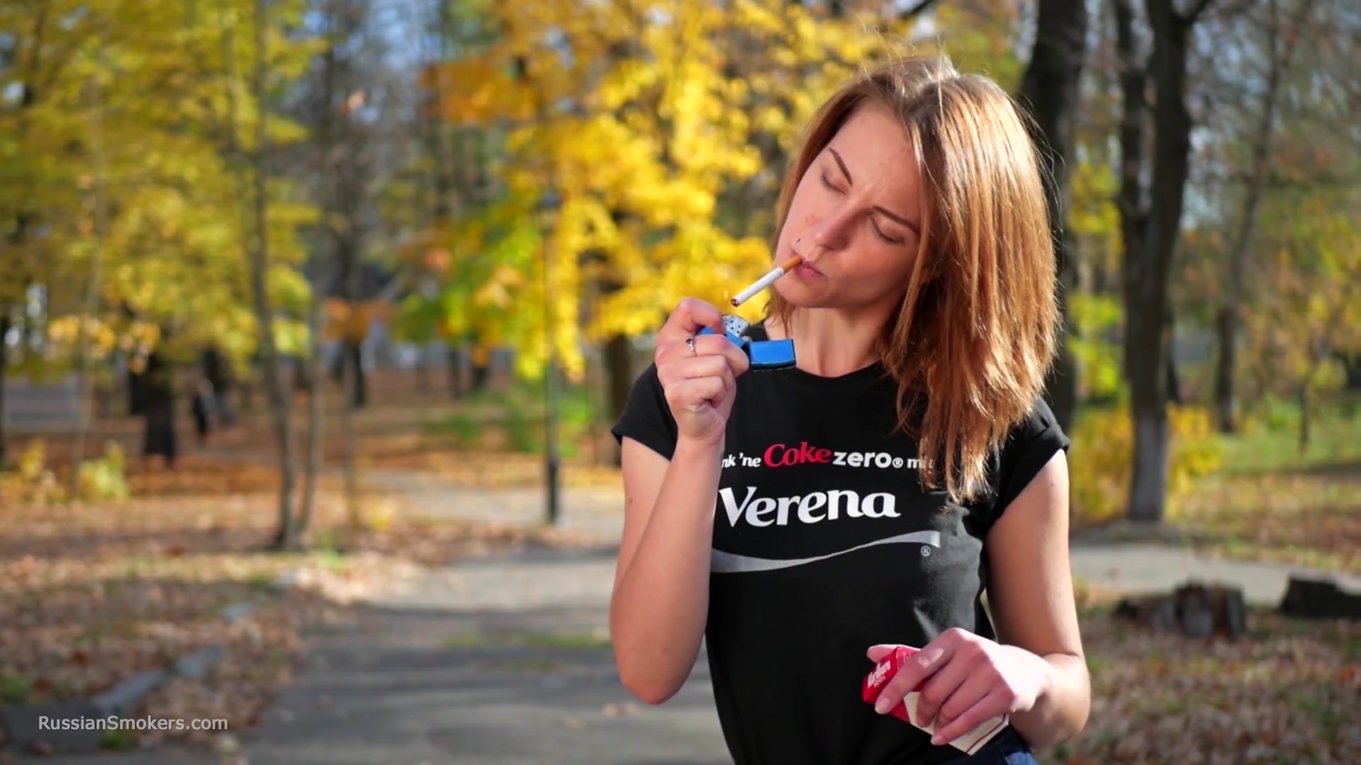 Sasha Is Smoking Two Cigarettes One By One In The Autumn Park