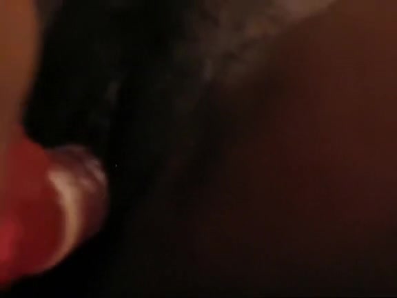 Sexy Ebony chick penetrating her hairy pussy with a red toy