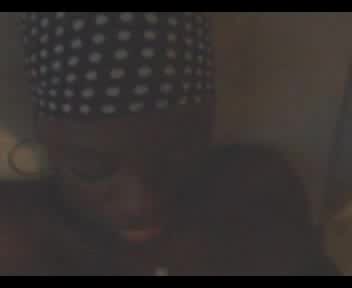 Black hussy in a dotted bandana receives cum in her mouth