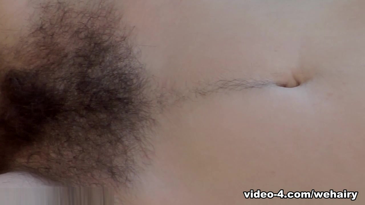 Camille undresses on white sofa to show hairy body
