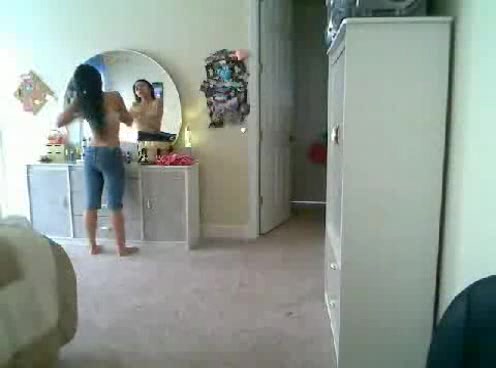Petite and sexy Japanese babe puts on clothes on the webcam