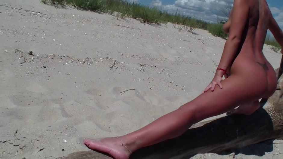 A couple of nudism lovers hardly pairing off on the sand
