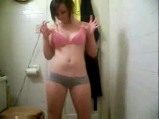 Small-titted babe dances and strips to the music