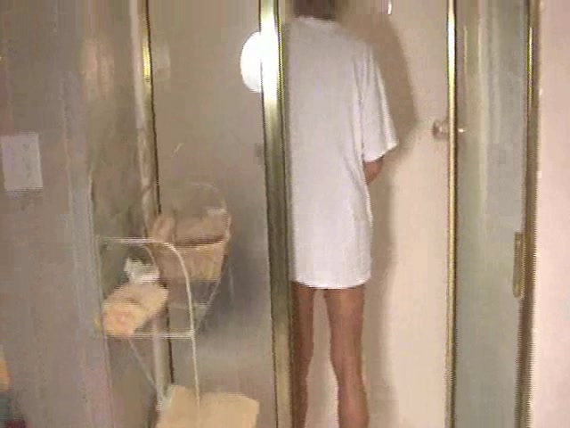 Skinny cute girl looks attractive in wet white T-skirt