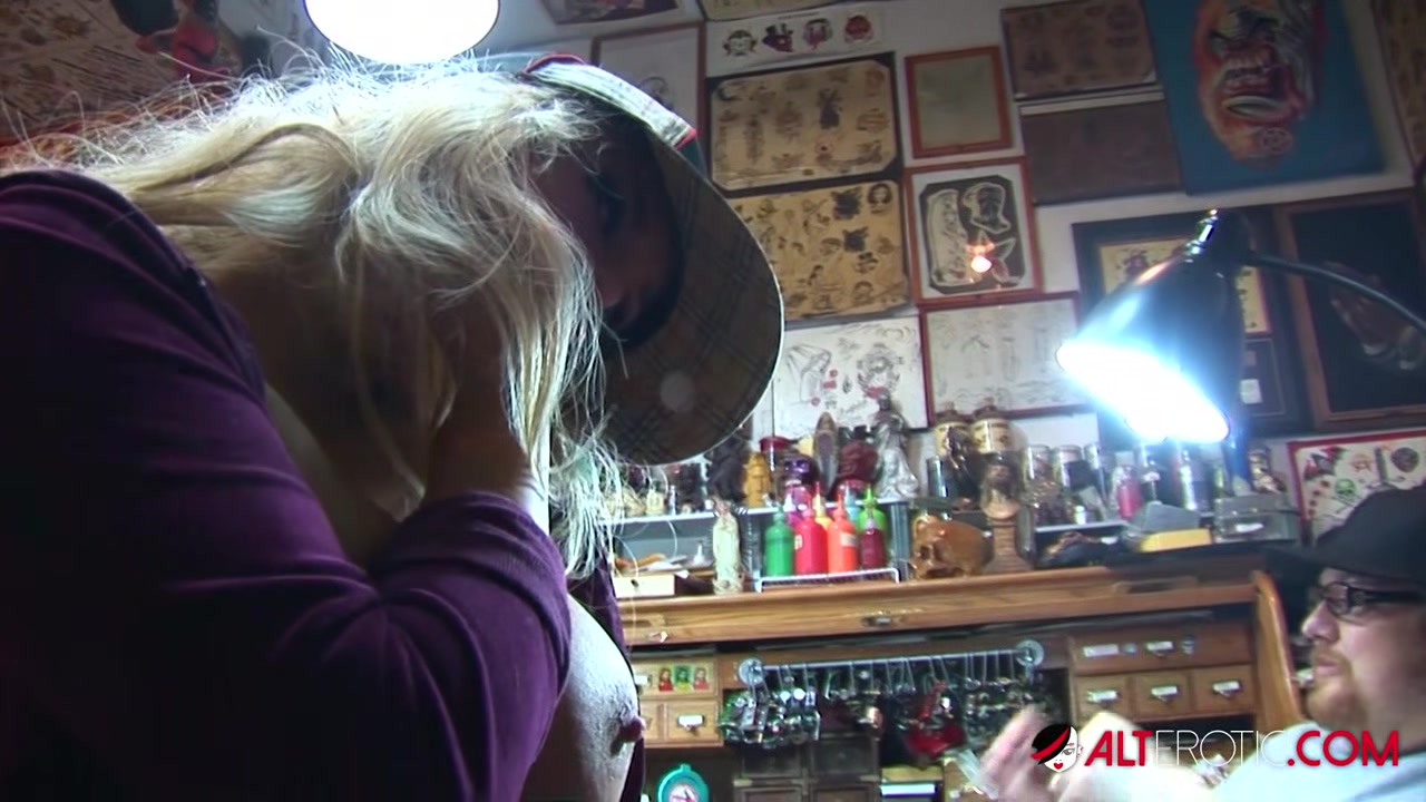 Shyla Stylez gets tattooed while playing with her tits