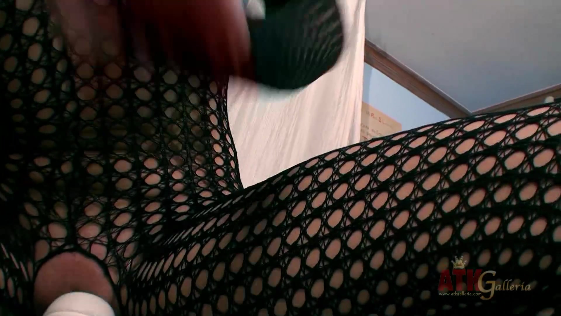 Izzy Champayne wearing fishnet bodystockings rubs pussy with hitachi