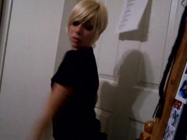 Short-haired blonde girl dances in the homemade video