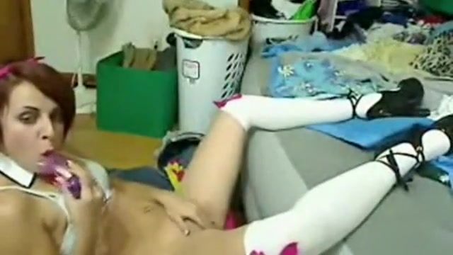 Cute girl spreading her legs and stuffs her pussy with a sex toy
