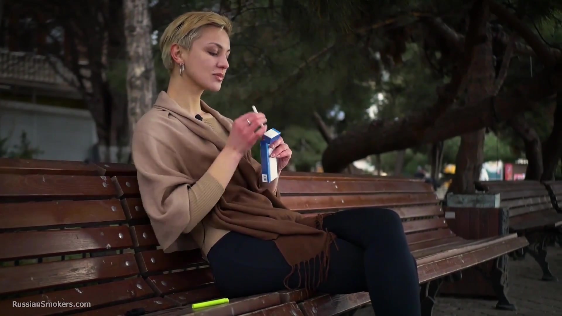 Short Cut Hair Blonde Girl Is Smoking All White 120mm Cigarettes